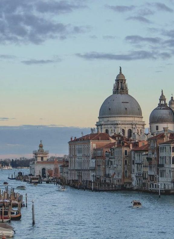 The Grand Canal in Venice at dusk, domes of Santa Maria della Salute beyond