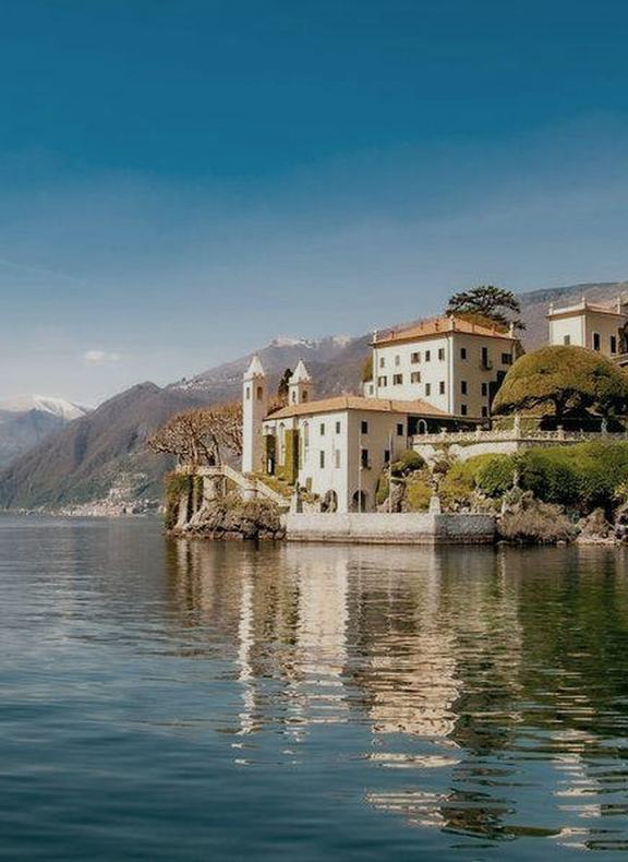 A villa and its gardens on a promontory over Lake Como