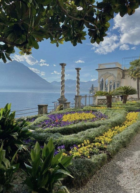 A formal lakeside garden in flower above Lake Como