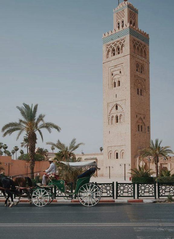 A horse-drawn carriage passing the Koutoubia minaret in Marrakech