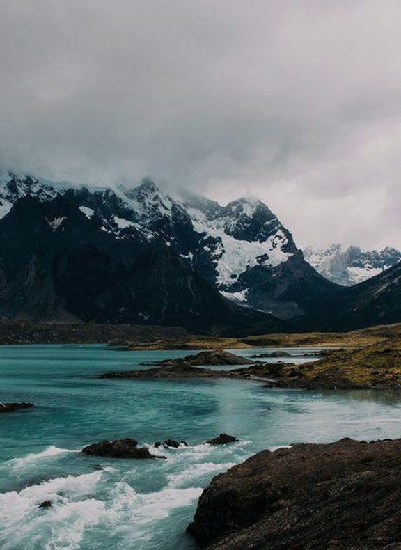 Snow-covered peaks above a glacial river in Patagonia